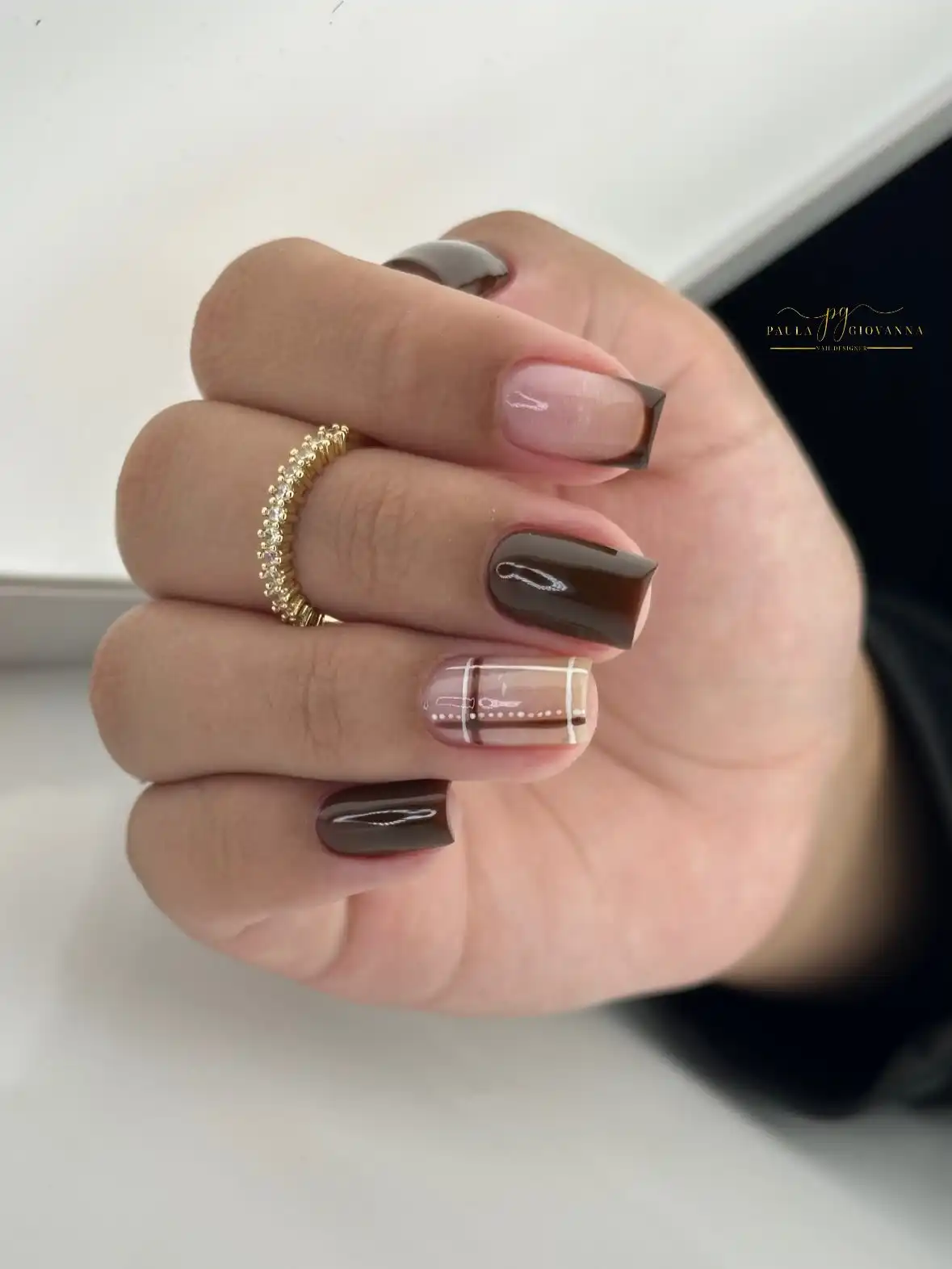 Glossy dark brown squares with grid-accent nail