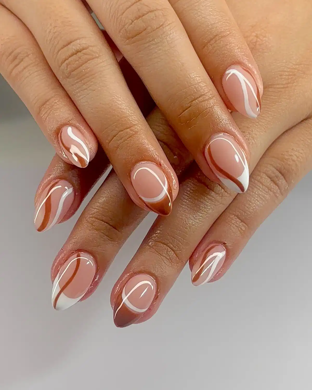 Nude base with white-and-brown swooping curves