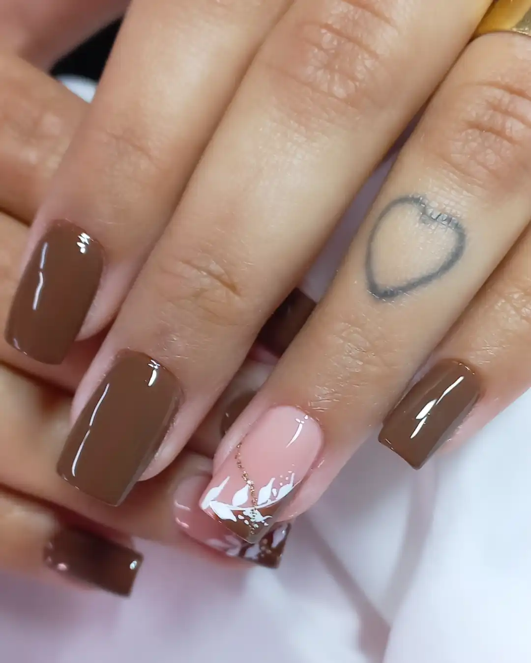 Glossy medium-brown squares with a pink accent and gold line detail