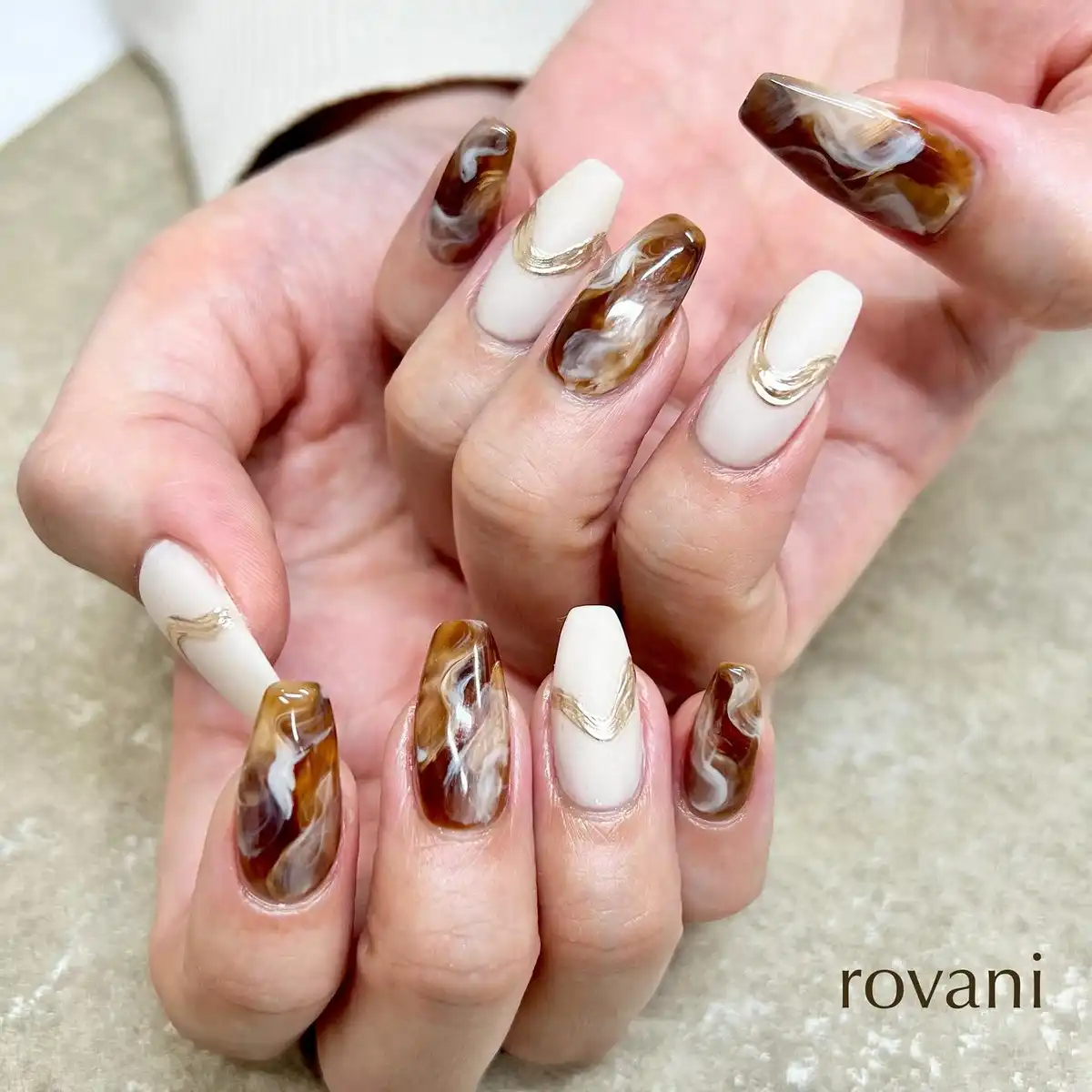 Cream and brown marbled swirls with gold accents