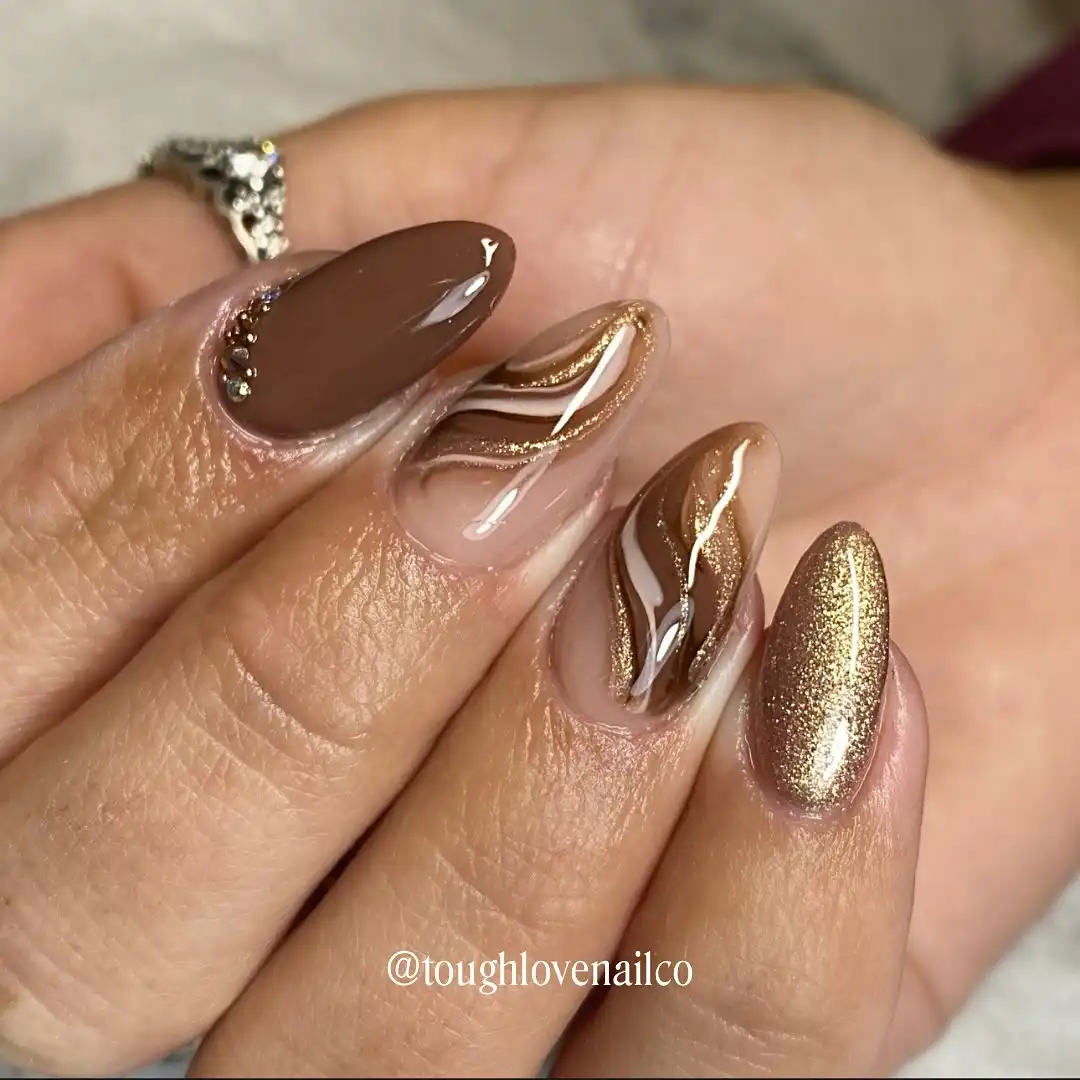 Wavy brown-and-white lines with glittery gold accents