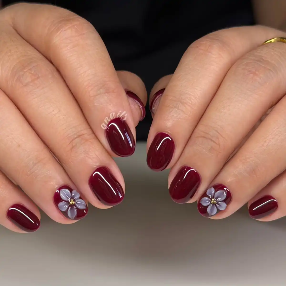 Solid maroon short nails with 3D gray flower accents
