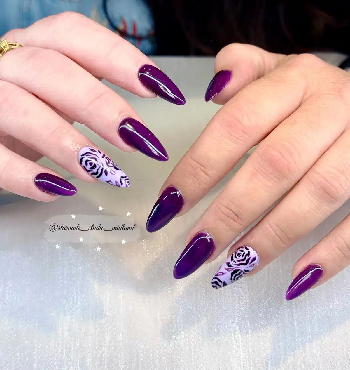 Deep purple stilettos with rose-pattern accent nails