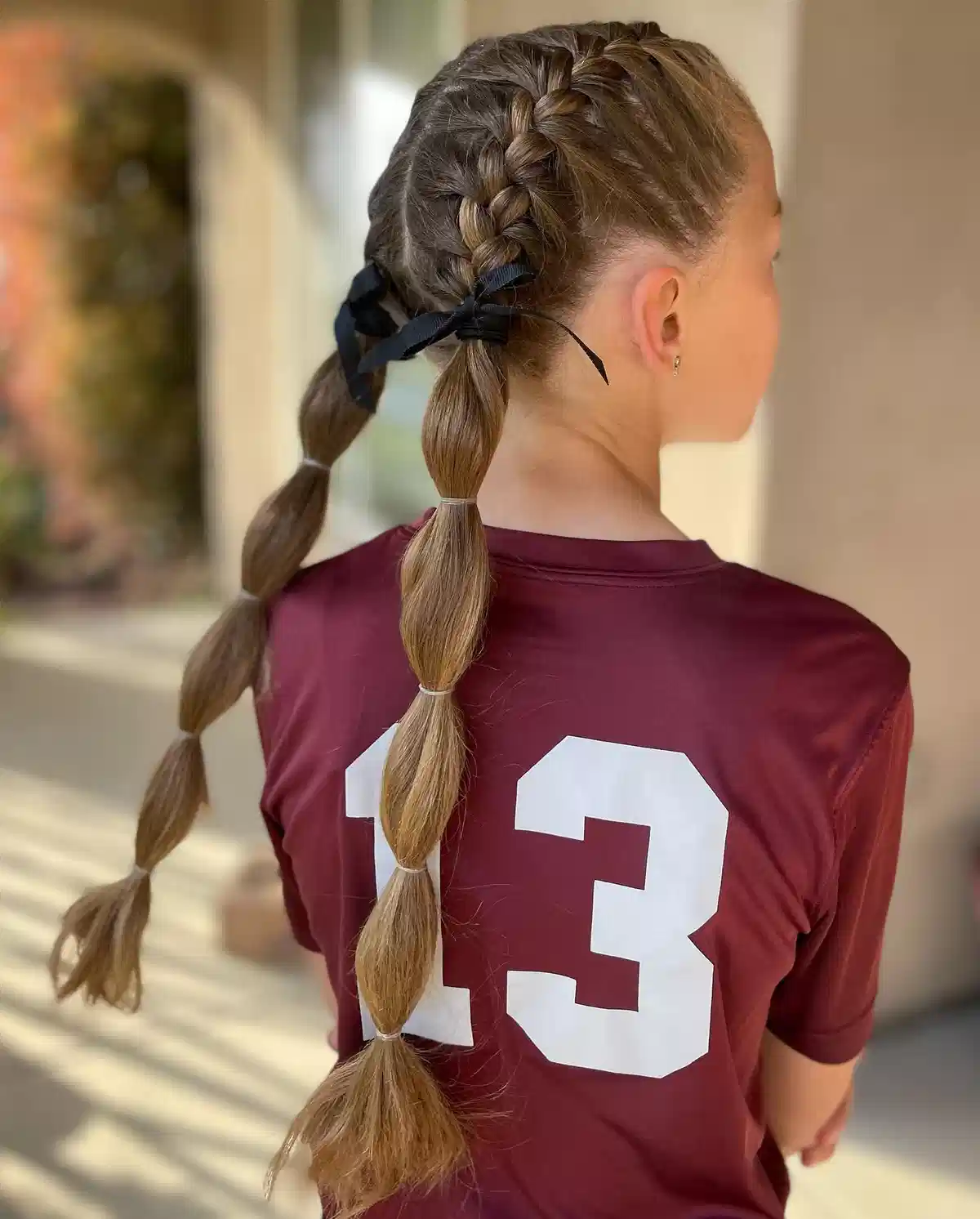 Braided back with bubble ponytail and black bow
