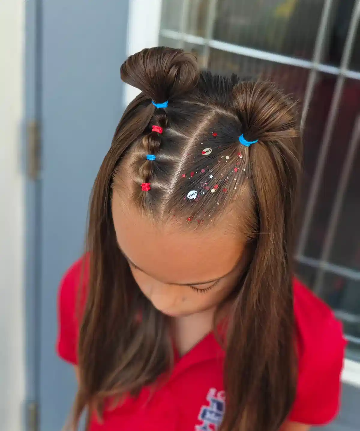 Double ponytail puffs with red/blue ties and hair confetti