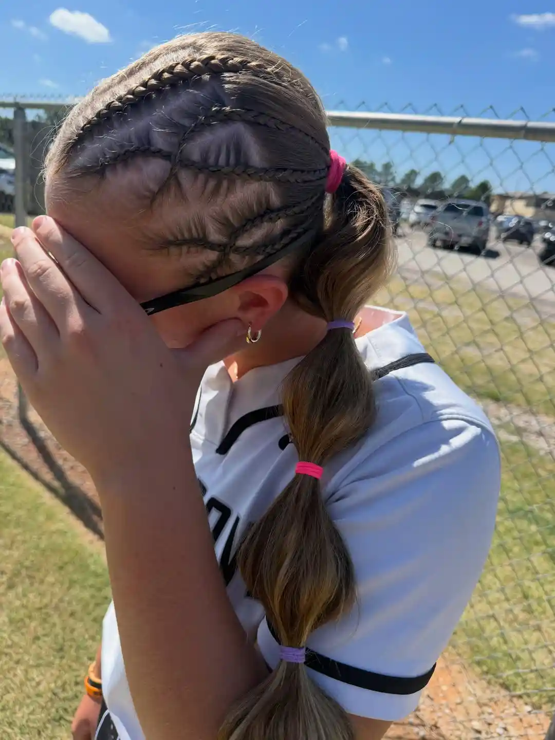 Curved mini-braids into bubble ponytail with pink/purple ties