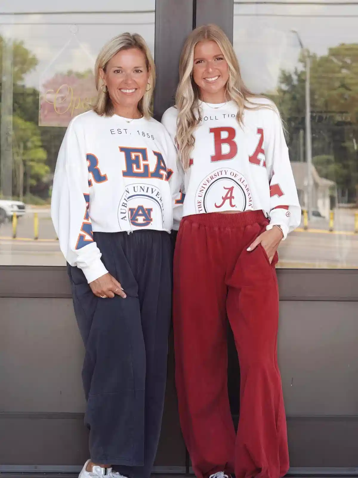 White collegiate sweatshirts with Auburn and Alabama graphics