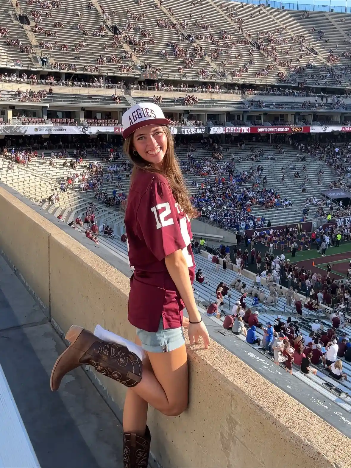 ‘AGGIES’ cap with maroon jersey and brown cowboy boots