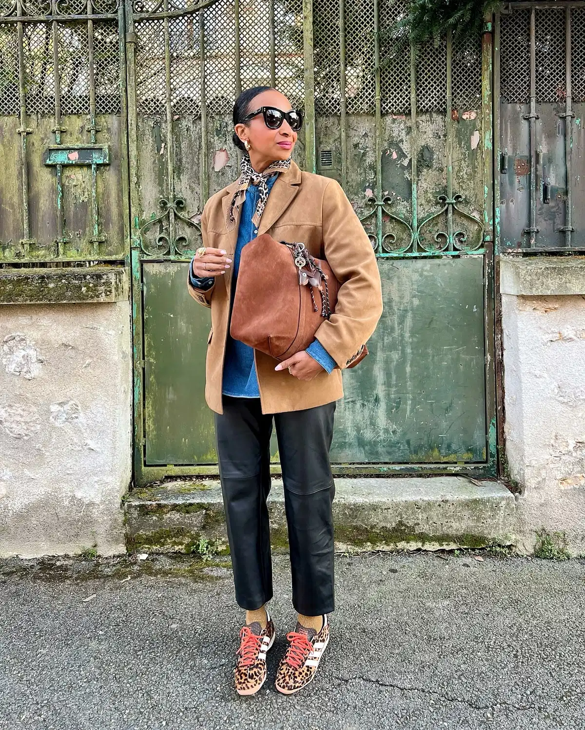 Tan jacket with leopard sneakers and black pants