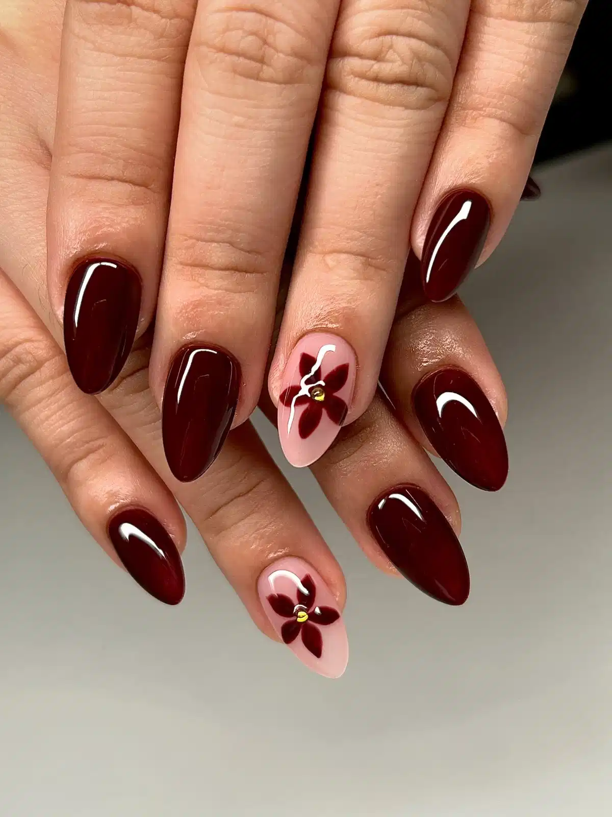 Solid maroon with pale pink floral accent nails