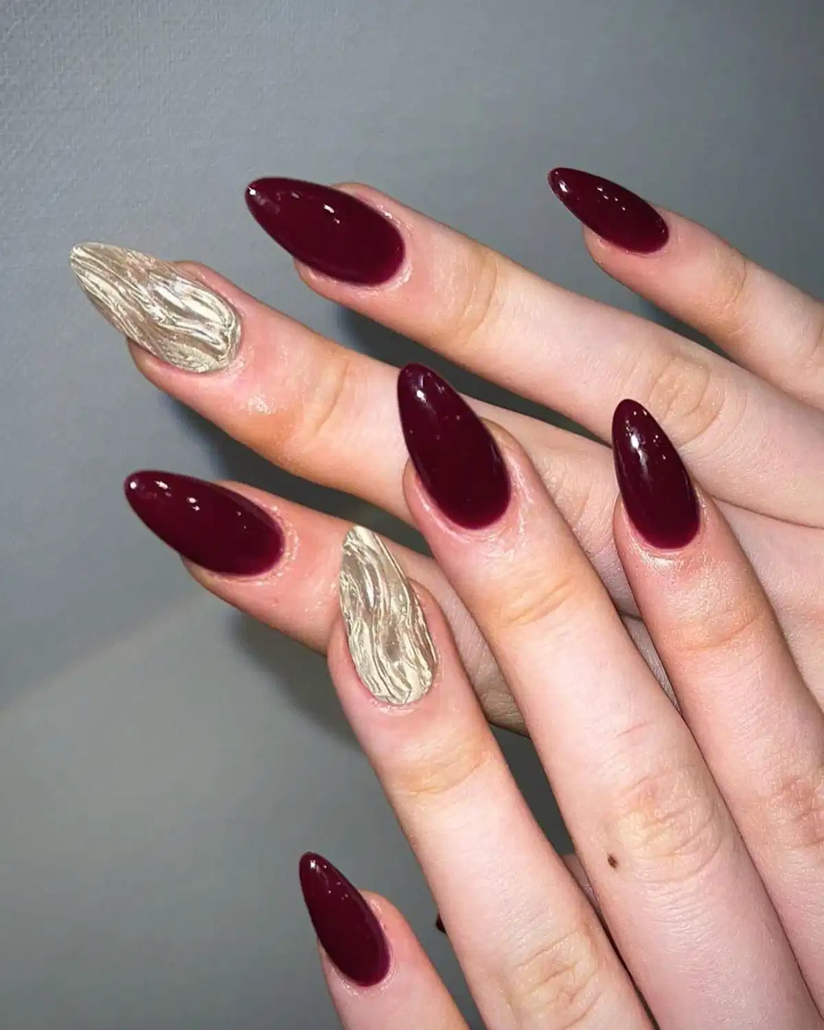 Deep maroon with textured metallic silver accent nails