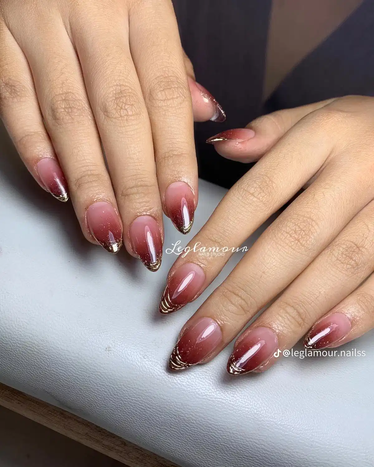 Nude-to-maroon ombré with fine gold tip lines