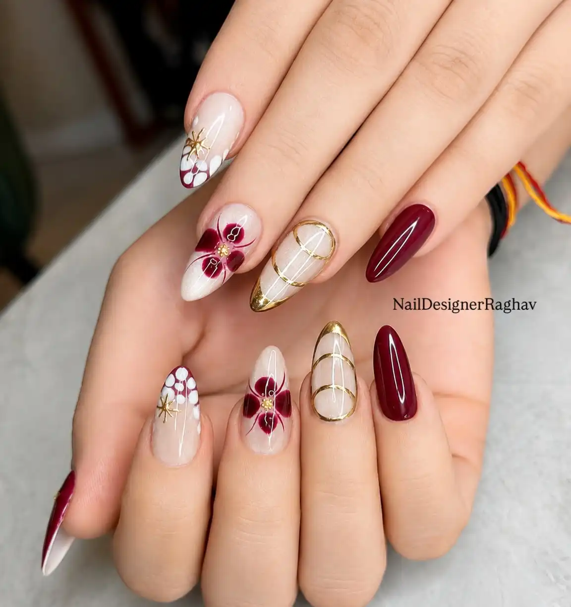 Maroon floral accents with gold tips and gold linework