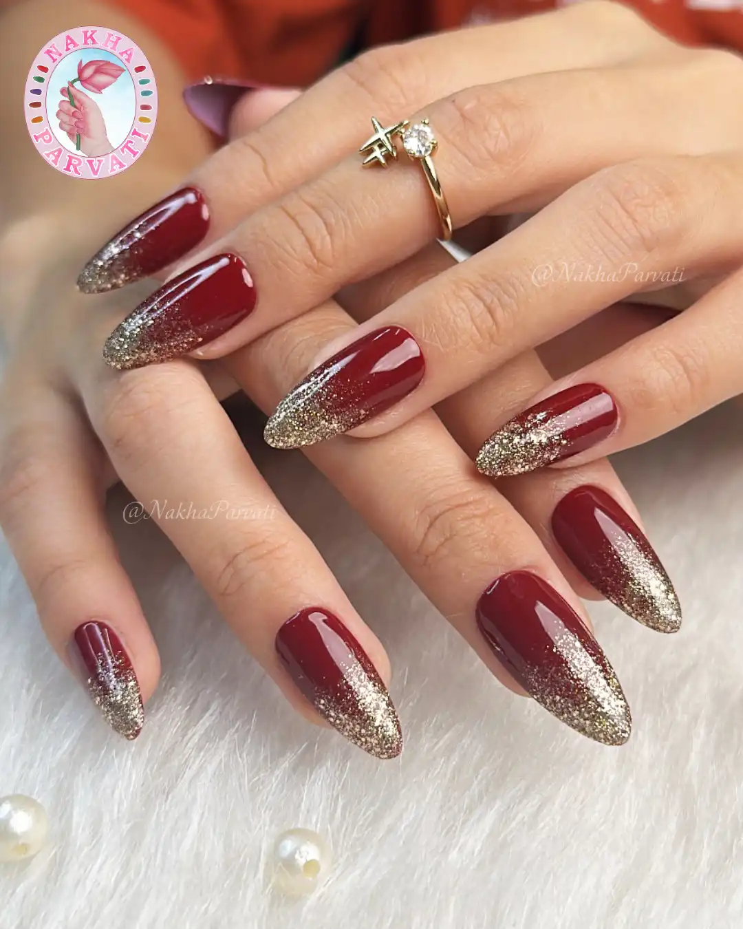 Maroon almond nails with gold glitter ombré tips