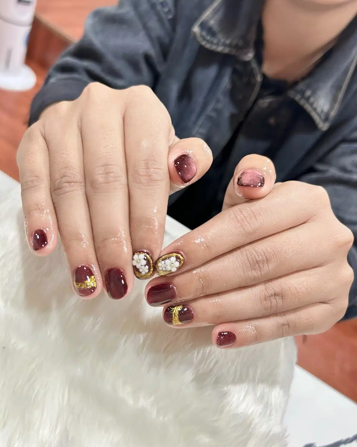 Short maroon set with gold bands and white floral accents