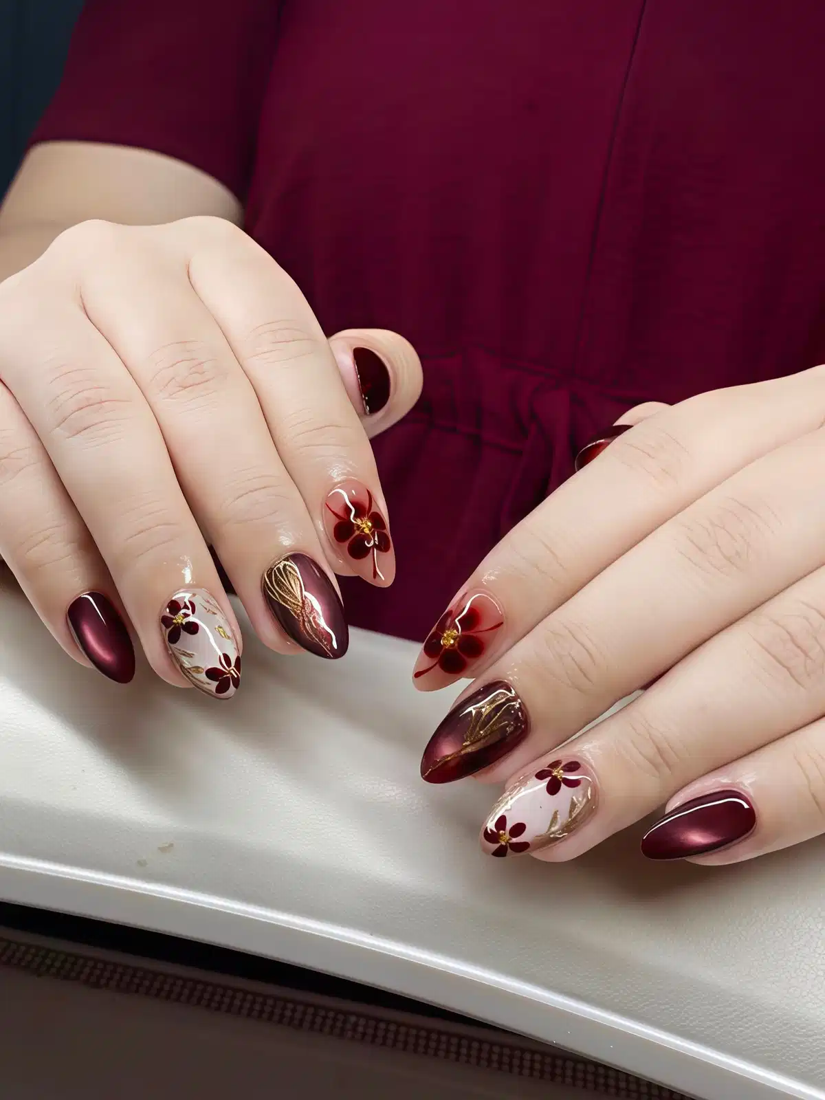 Maroon floral motifs on nude and white with gold details