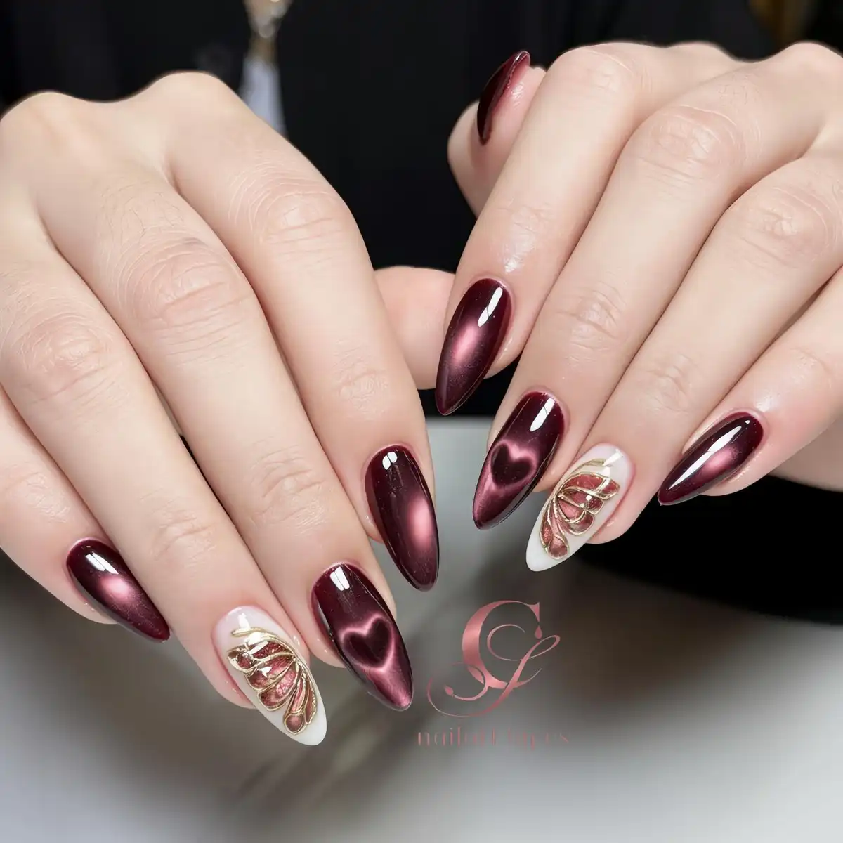 Metallic maroon shine with white accent nails and gold linework