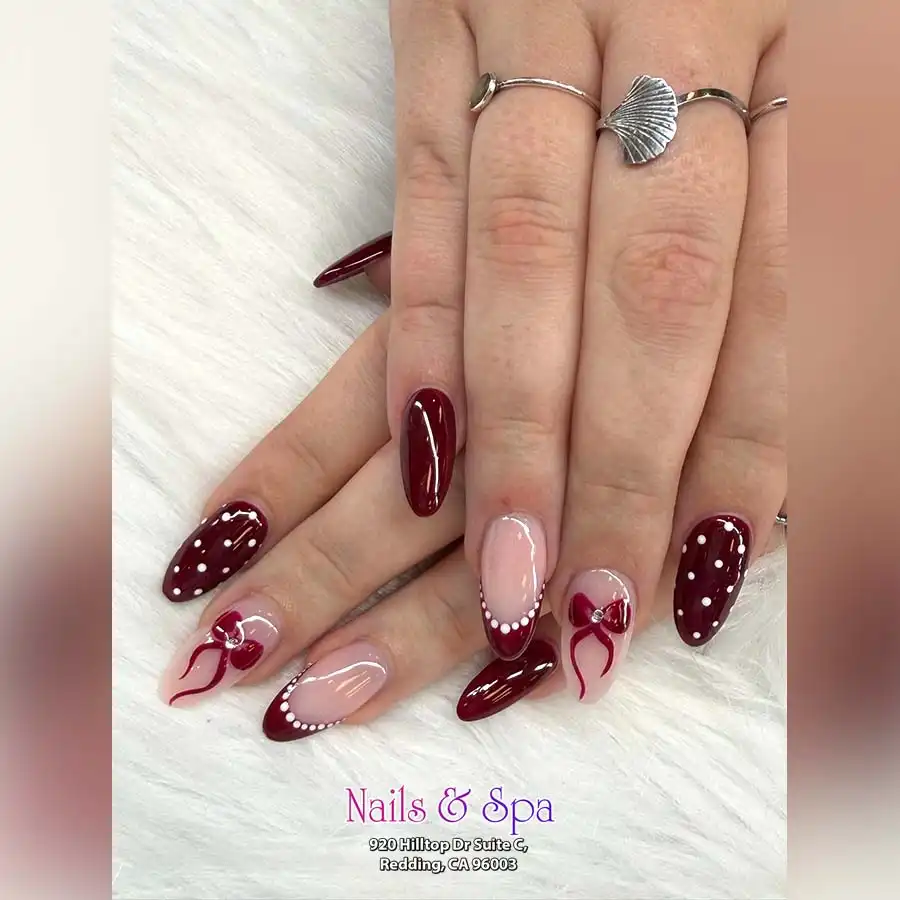 Maroon polka dots and dotted French tips with bow accents