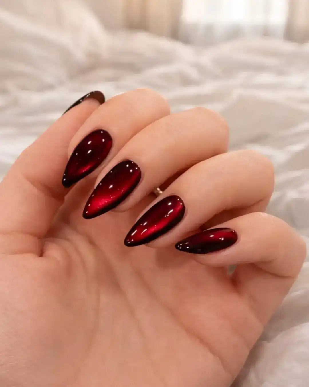 Dark maroon stiletto cat-eye with vivid red center glow