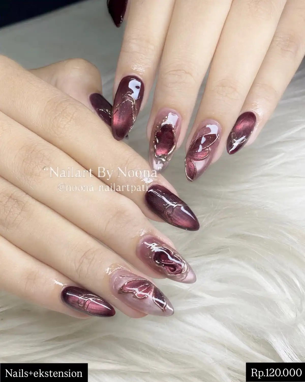 Maroon cat-eye hearts with white line accents on nude base
