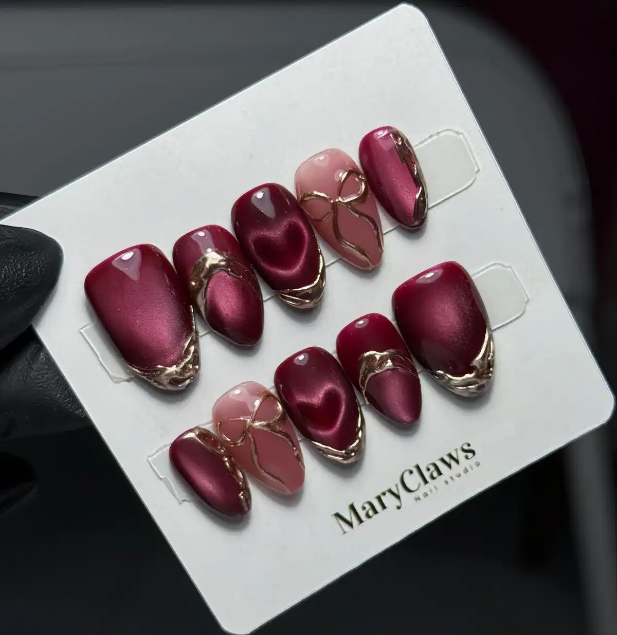 Maroon cat-eye set with gold edging and bow accents