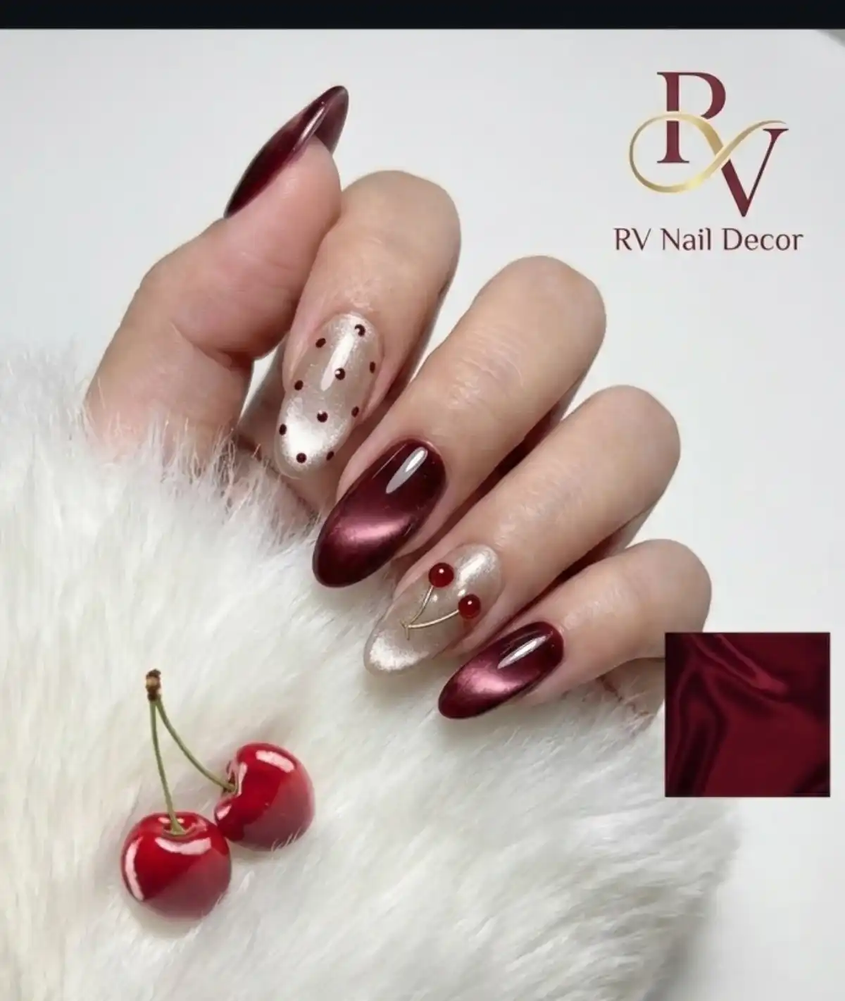 Maroon cat-eye with champagne dotted accents and cherry motif