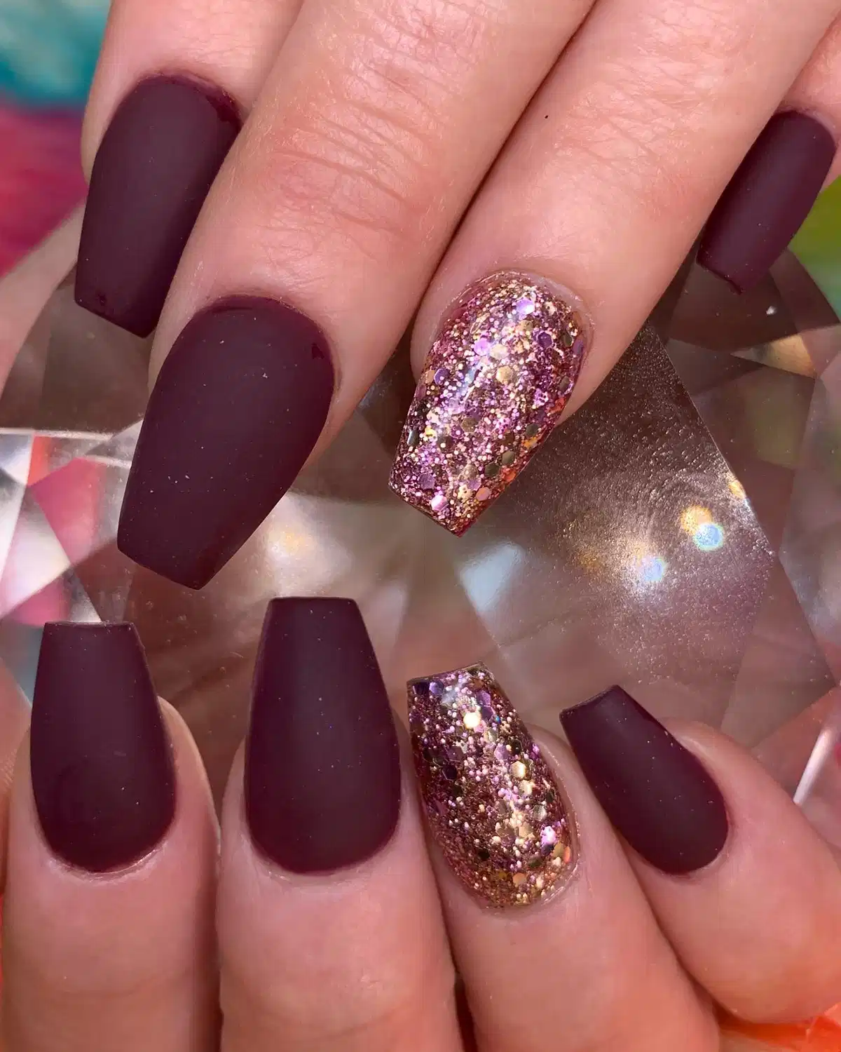 Matte maroon coffin nails with chunky glitter accent nails