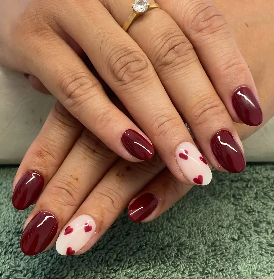 Glossy burgundy nails with white heart accent nails