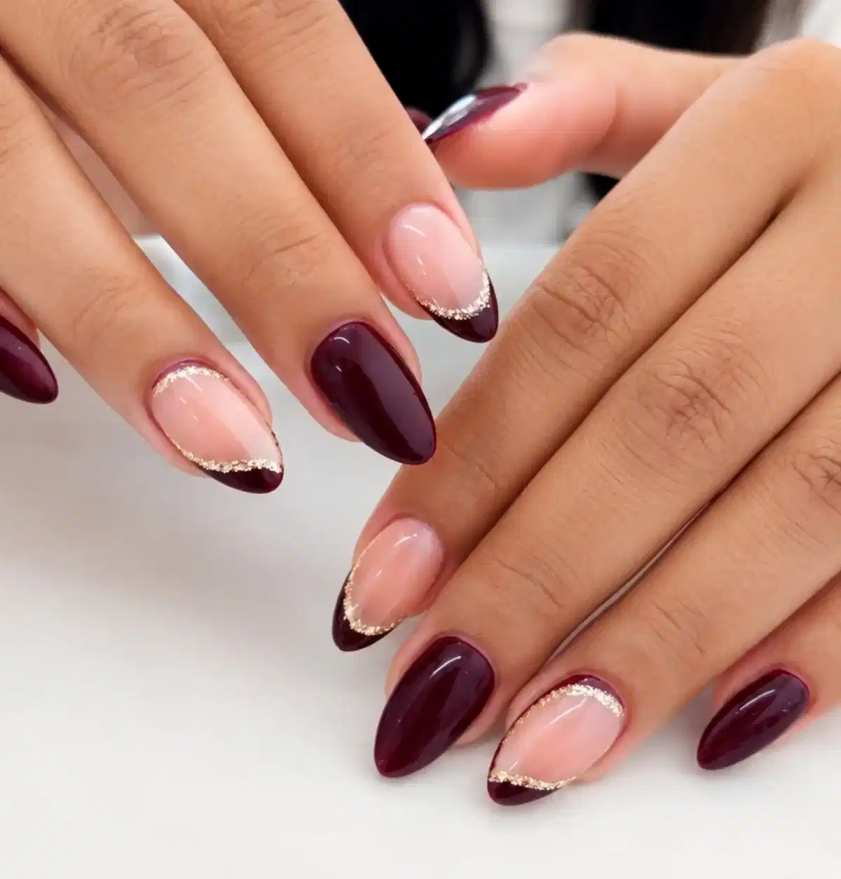 Deep Maroon Almond Nails with Gold-Edged French Tips