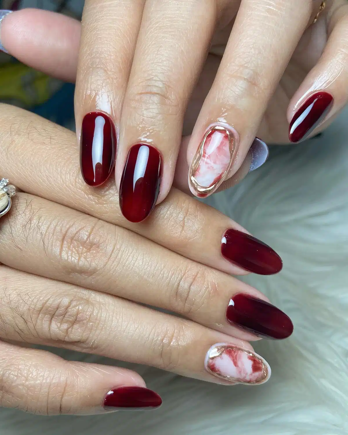 Glossy maroon with pink marble accents and gold outline
