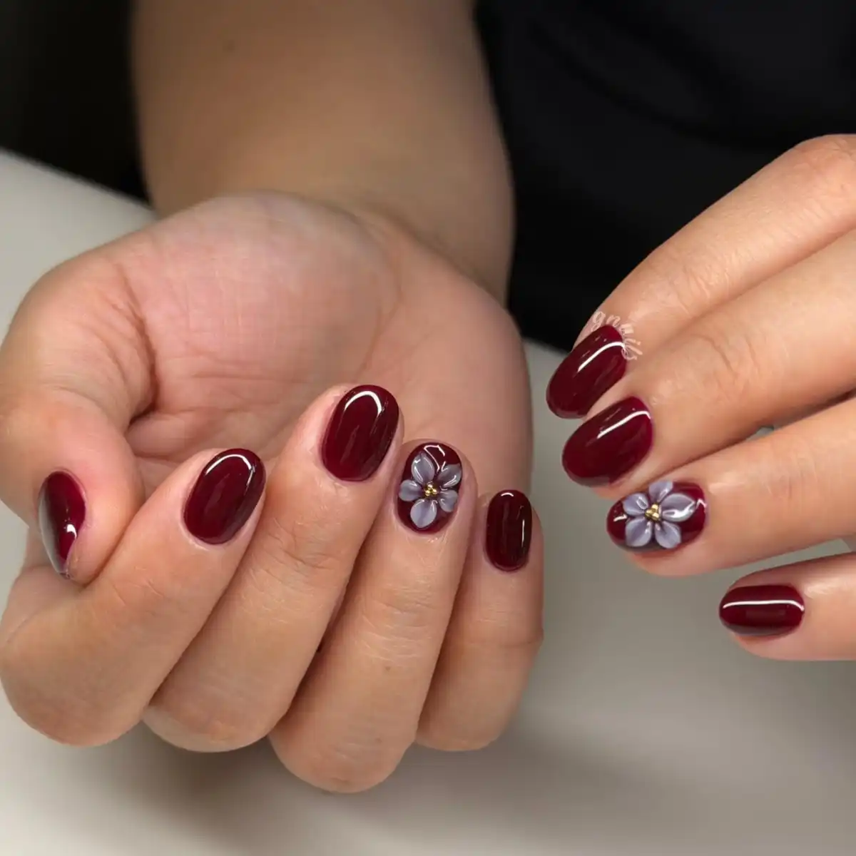 Glossy maroon short nails with 3D lavender flower accents