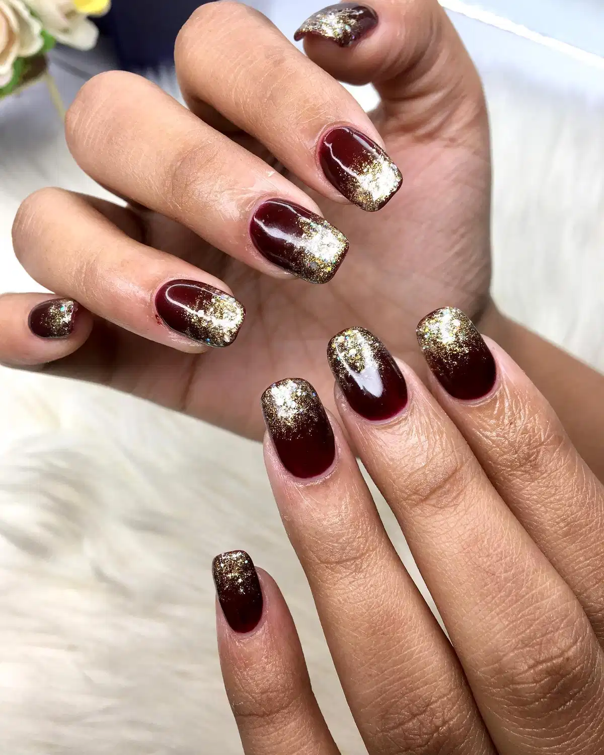 Glossy maroon squares with gold glitter gradient tips