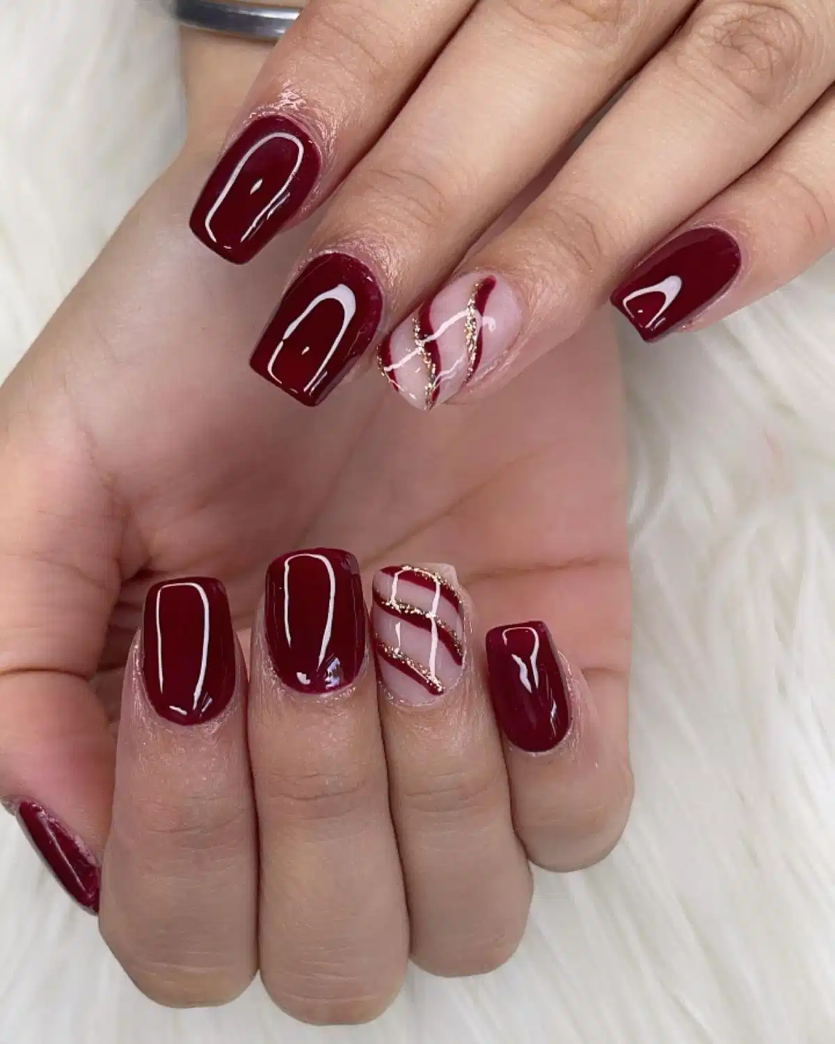 Glossy maroon squares with nude crisscross accent nails