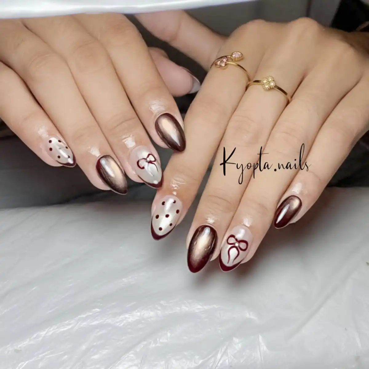 Nude and maroon polka dots with bow art and accent nails
