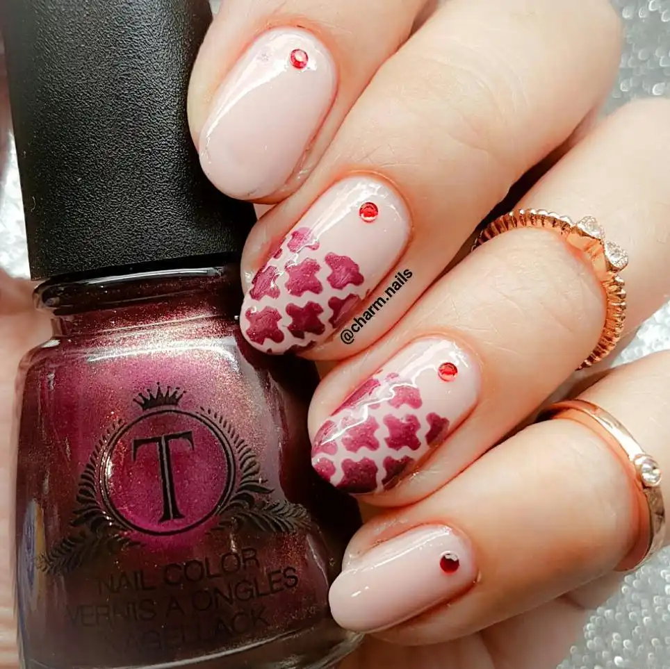 Nude base with maroon floral pattern and red studs