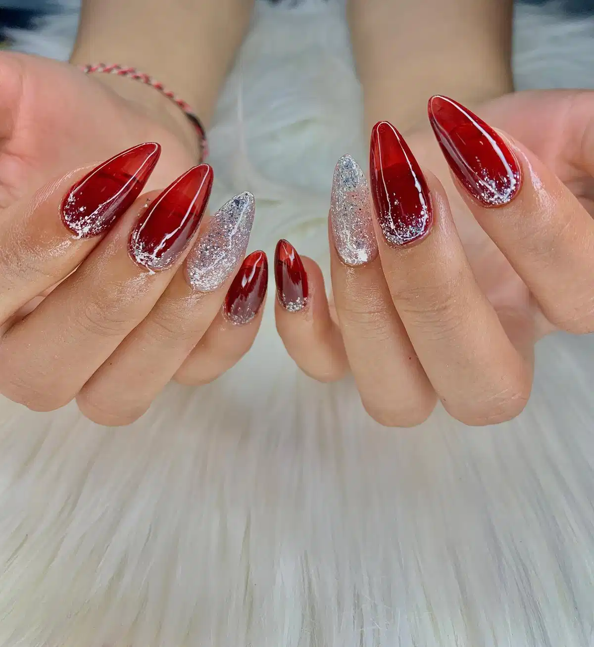 Long maroon stilettos with silver glitter tips and full-glitter accents