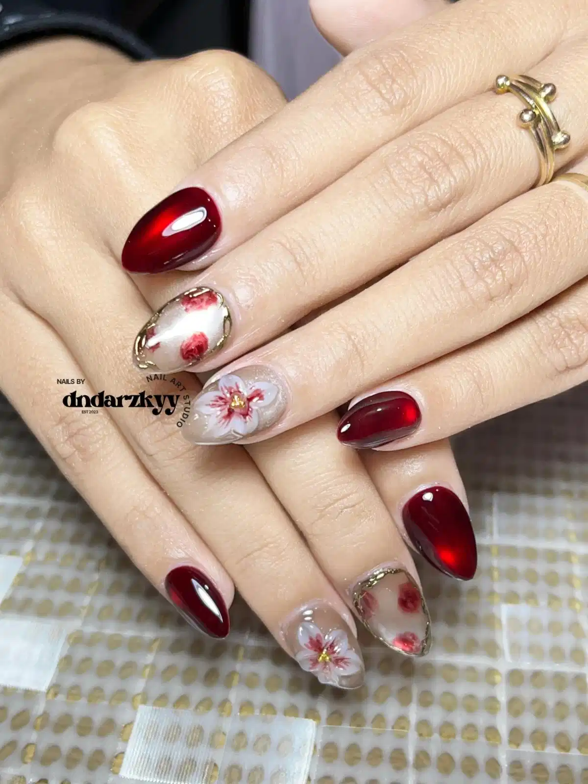Deep maroon glow with floral and framed accents
