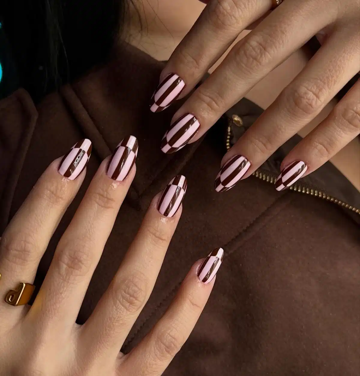 Vertical brown stripes over a light pink base