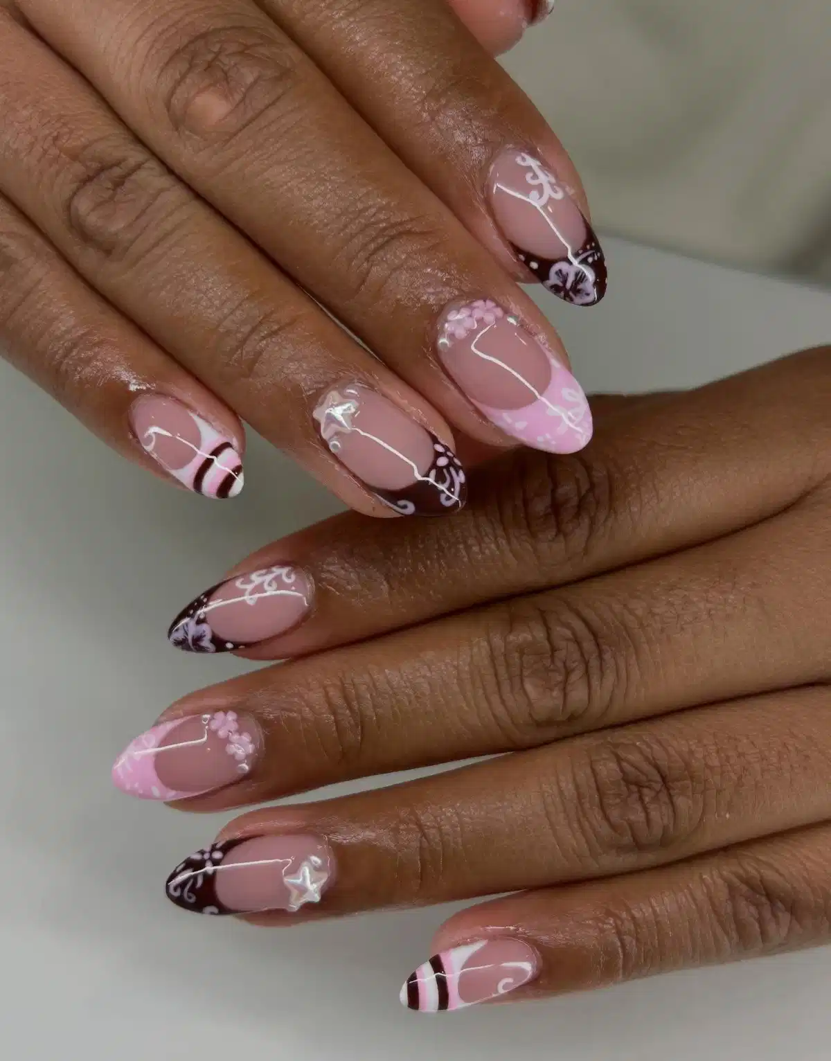 Nude base with brown tips and white swirls