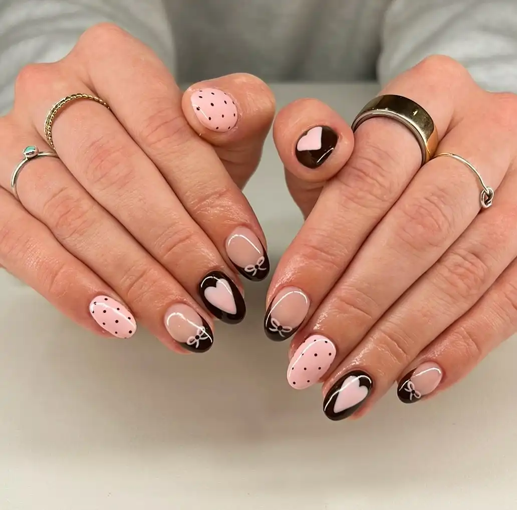 Brown French tips with hearts, bows, and pink dotted accents