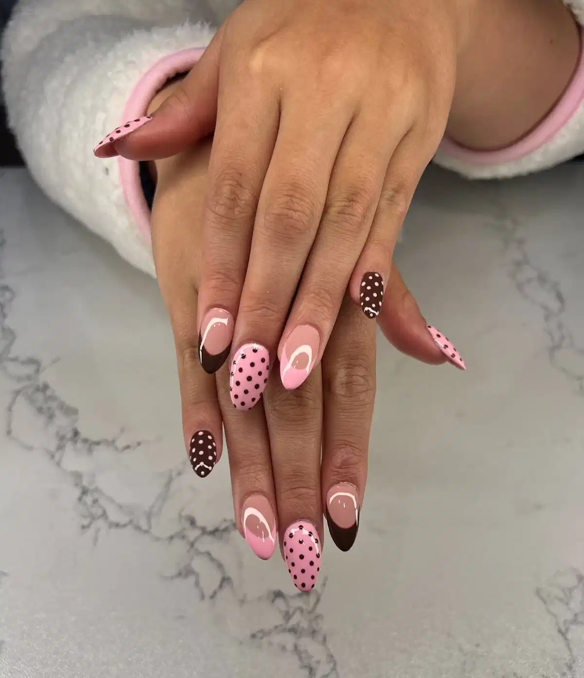 Nude-and-brown French tips with pink and brown polka dots