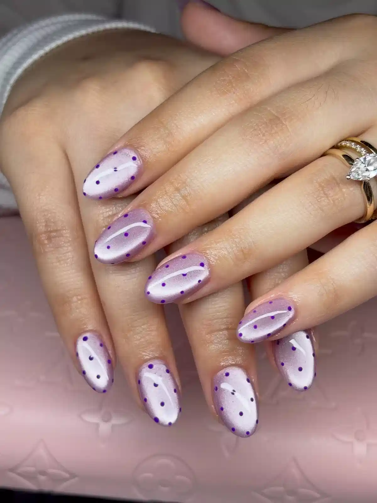Pale lavender pearly nails with purple polka dots