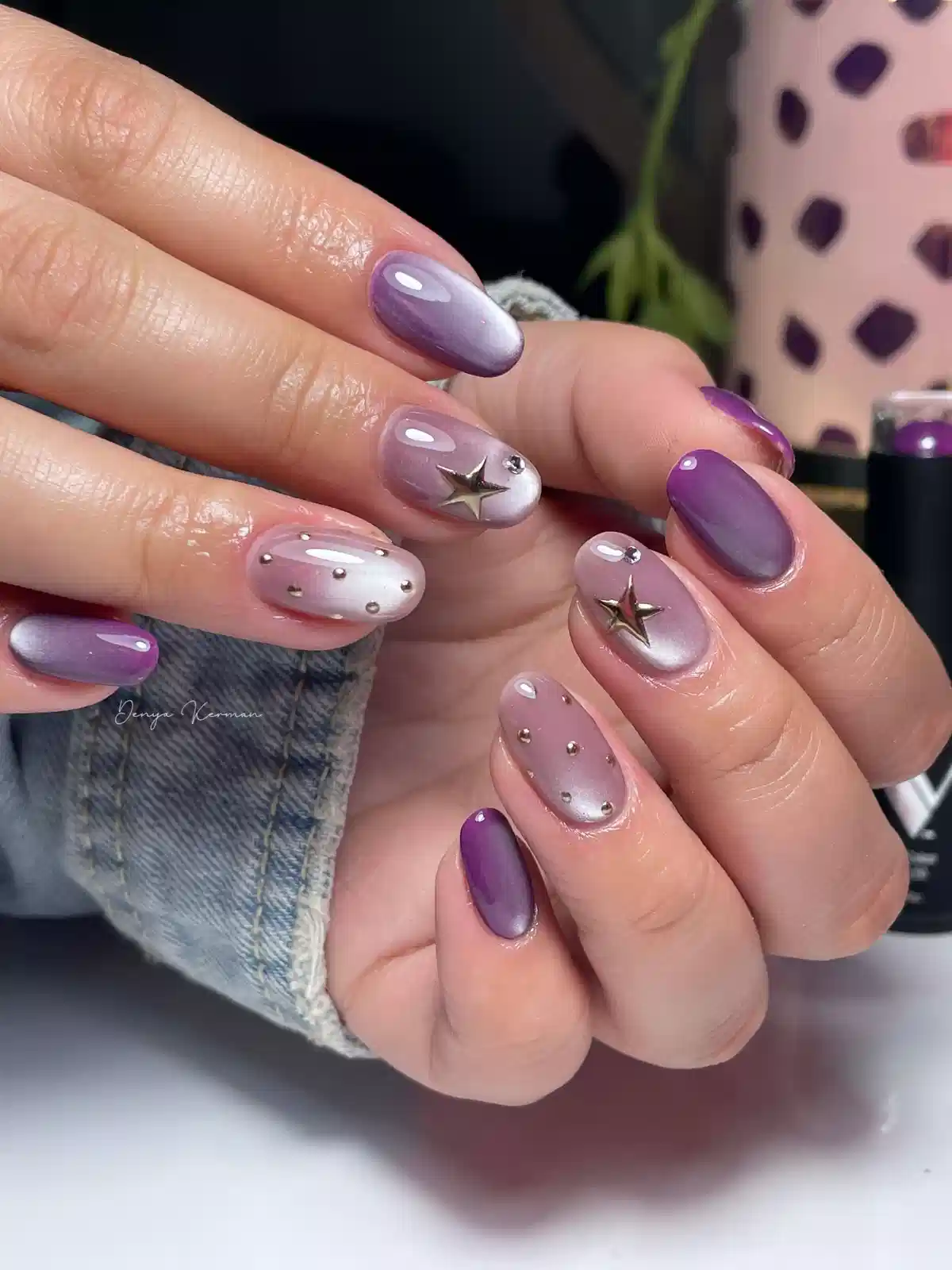 Lavender-to-silver reflective nails with metallic studs and raised star charms