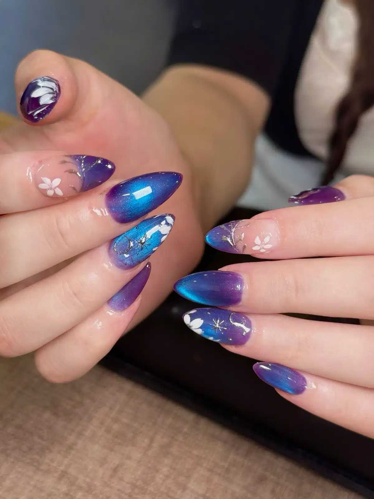 Purple-to-blue gradient with white floral and starburst details