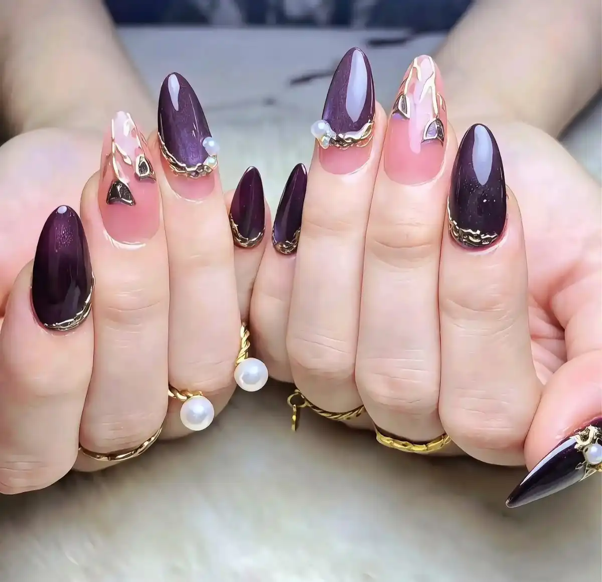 Glossy deep purple with nude-pink accents and gold-trim details