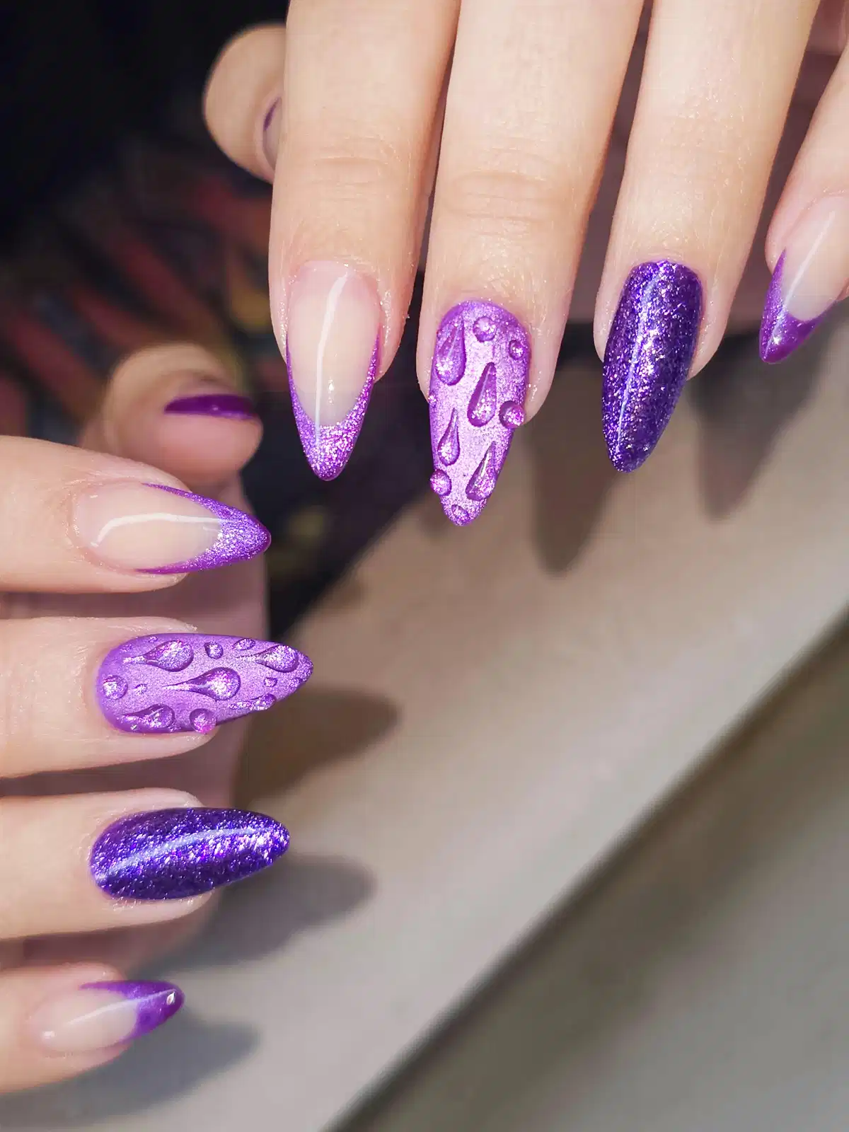Purple glitter tips with raised droplet texture accents