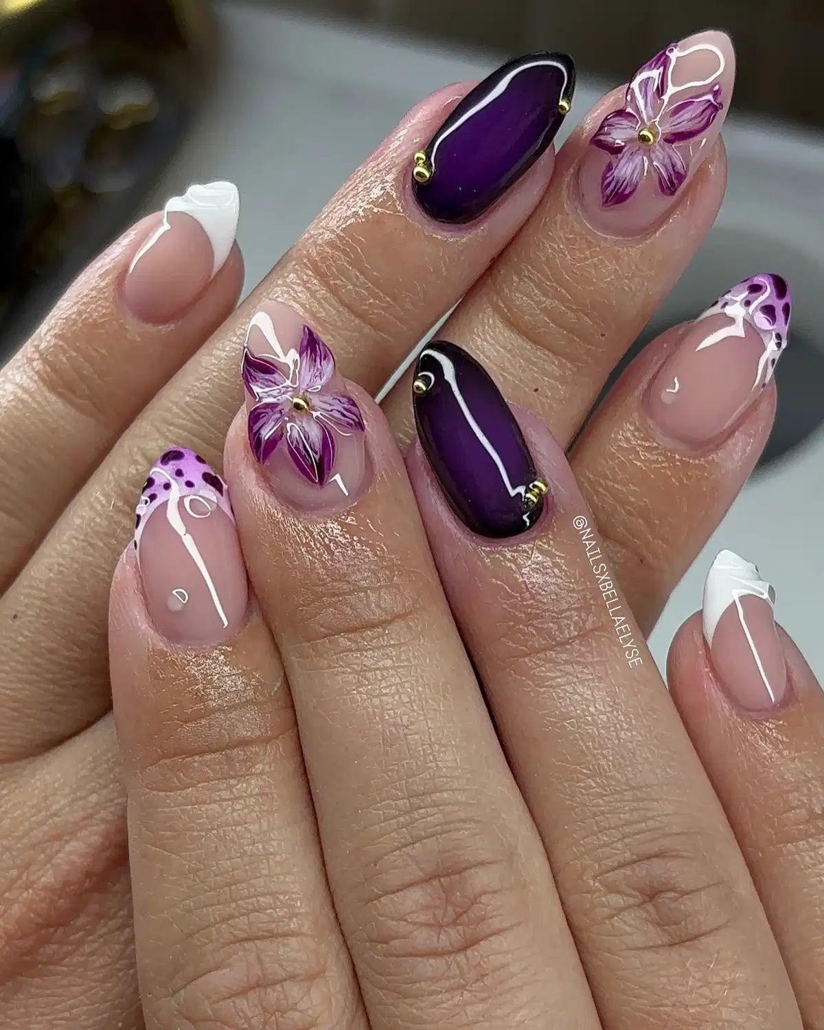 Deep purple accents with floral art and mixed French tips