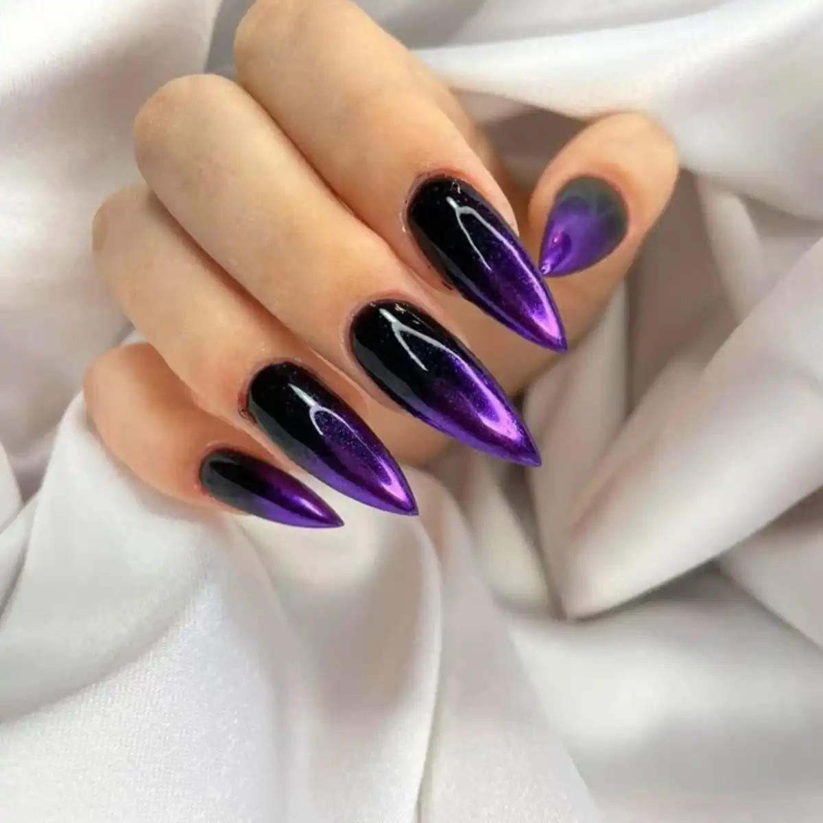 Black and purple stiletto nails with high-shine gradient