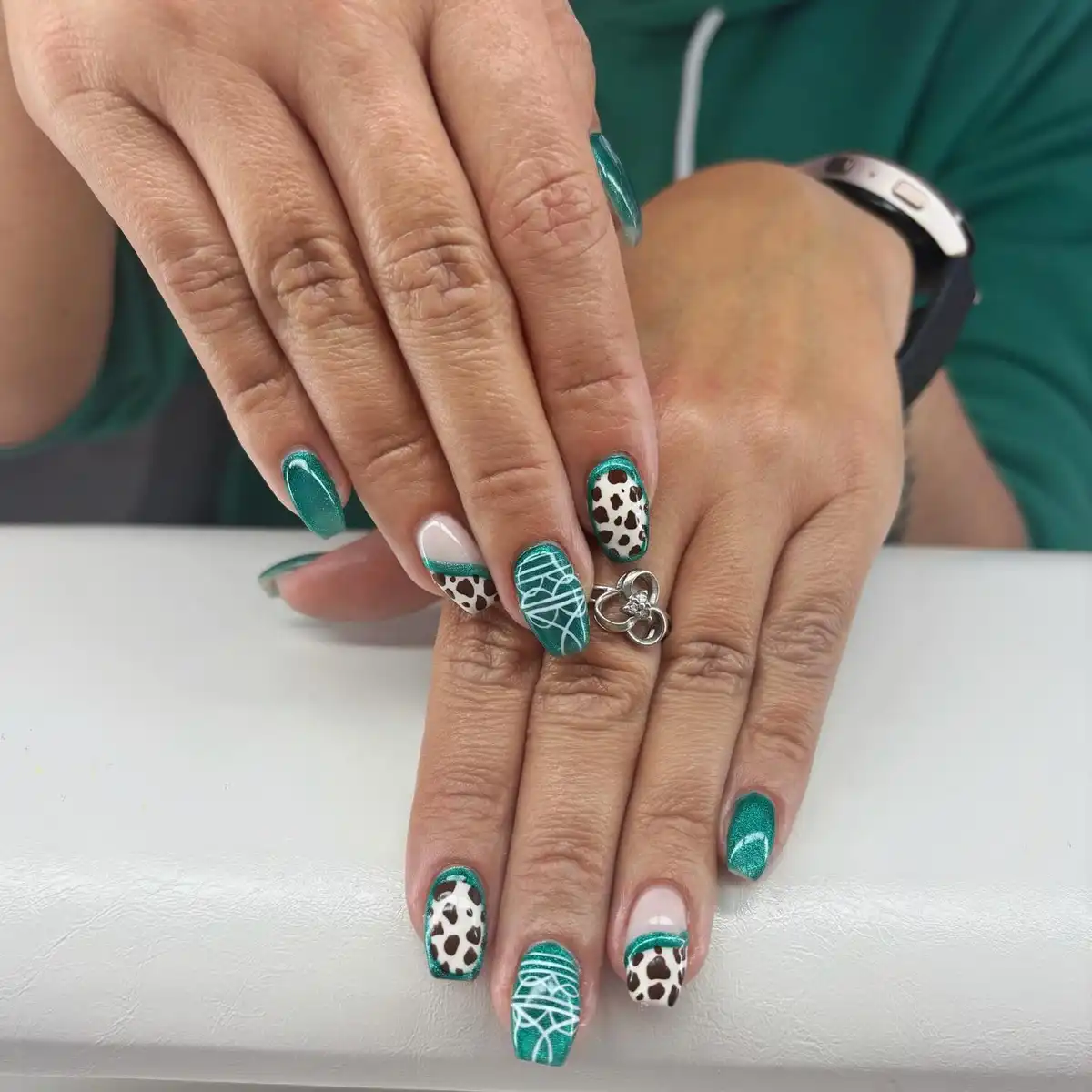 Teal glitter with cow print and white linework