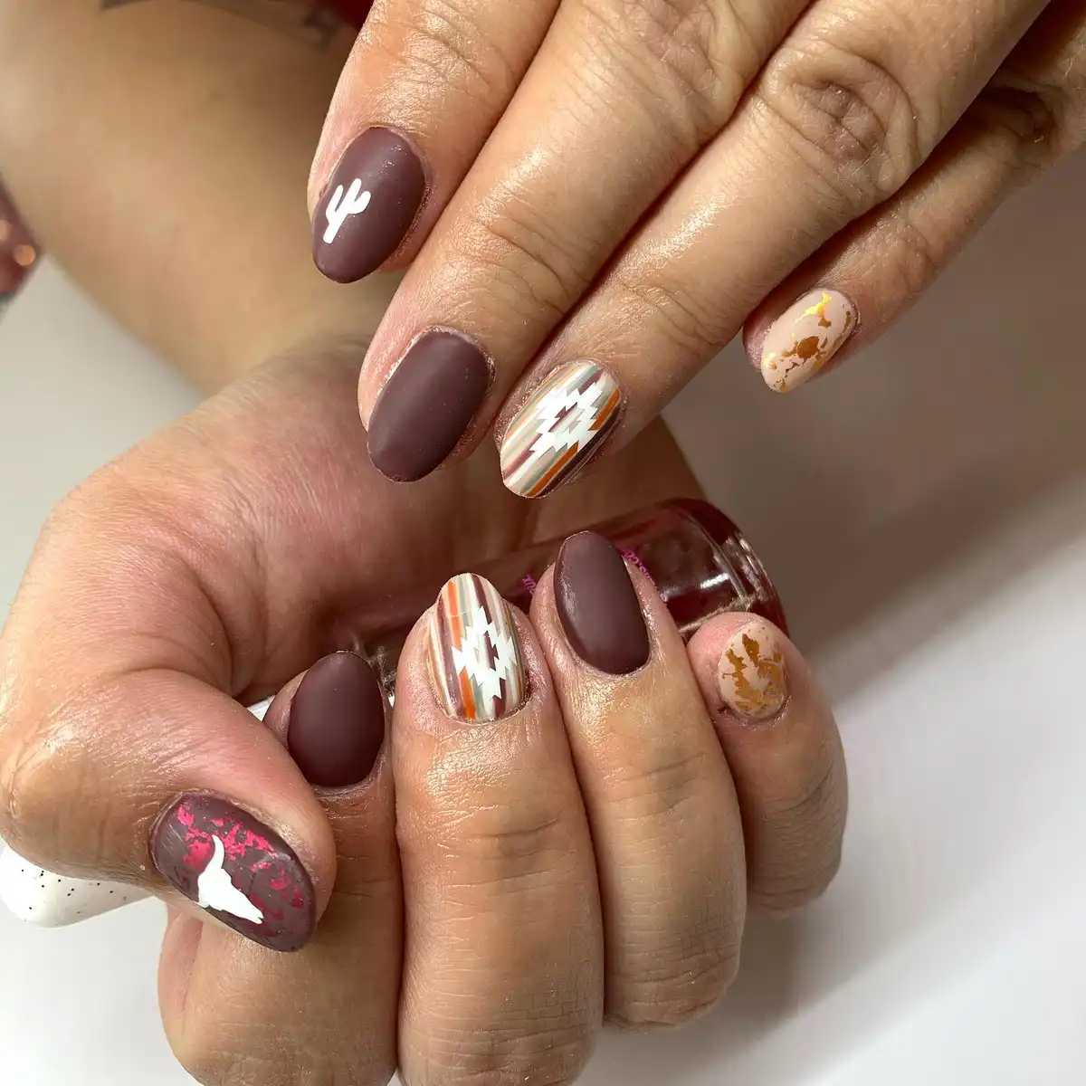 Matte browns with cactus silhouettes, geometric stripes, and foil-like accents